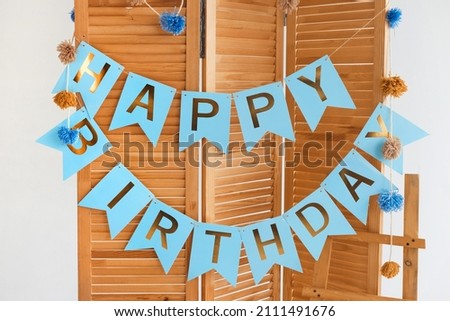 A cute and stylish eco-friendly details of children's place from natural materials and a Happy Birthday garland for a little boy's greeting party