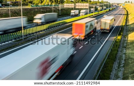 Trucks on six lane controlled-access highway in Poland.
 Royalty-Free Stock Photo #2111492984