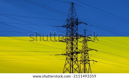 Ukrainian flag with electric tower and lines. Energy supply in Ukraine. High electricity and energy market prices. Crisis situation. Royalty-Free Stock Photo #2111493359