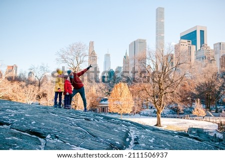 Family of father and little kids in Central Park on winter vacation in NYC