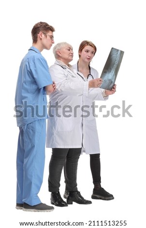 Group of serious doctors and nurses looking at X-ray