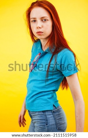 young pretty teenage girl emotional posing on yellow background, fashion lifestyle people concept