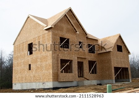large two story family home under construction roof modern