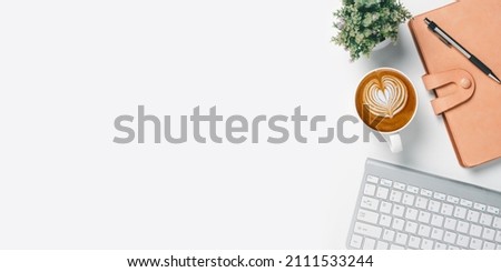 Office desk with computer, Pen, Notebook and Cup of coffee on white background, Top view with copy space, Mock up.	