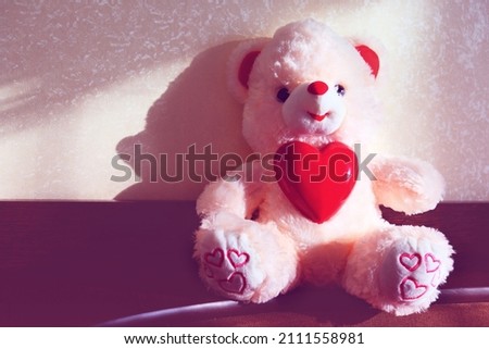 Toy bear with a heart.  Preparation for a romantic holiday at home, soft morning light. Valentines Day, Birthday  and love Concept