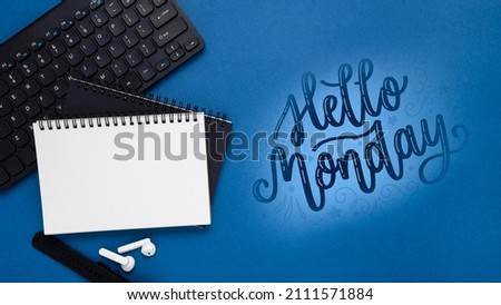 Monday concept with text hello monday notepad and black keyboard. 