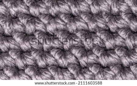Merino wool handmade knitted large blanket, super chunky yarn, trendy concept. Close-up of knitted blanket, merino wool background Royalty-Free Stock Photo #2111603588