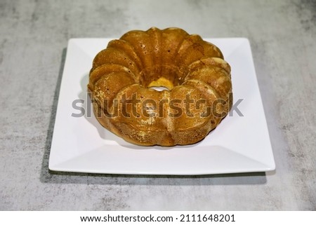 A poppy seed Bundt cake on a white plate.