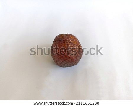 The skin of the salak fruit has a brownish yellow-like texture and is arranged in layers