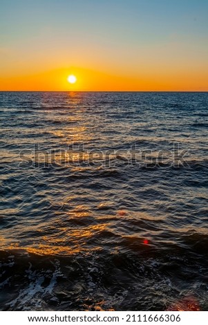 Sea landscape. Surfline with waves and foam at sunset time. Nature background