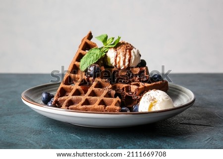 Plate of delicious Chocolate Belgian Waffles with ice cream and blueberry on table Royalty-Free Stock Photo #2111669708