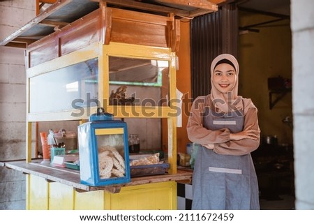proud muslim woman with her small food stall Royalty-Free Stock Photo #2111672459