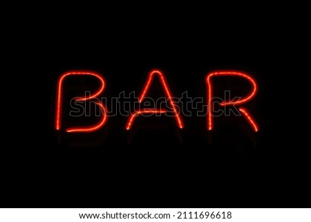 Retro neon sign with the word bar. Vintage electric symbol. Burning a pointer to a black wall in a club, bar or cafe. Design element for ad, signs, posters, banners