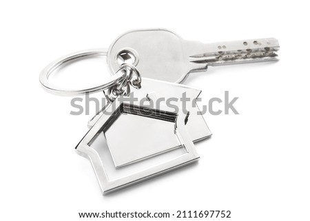 Key with house shape keychain on white background