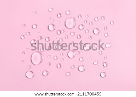 Water drops on pink background Royalty-Free Stock Photo #2111700455