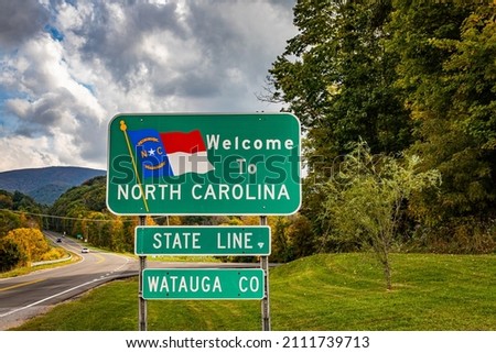 A Welcome to North Carolina sign on the highway marking the state border with Tennessee.