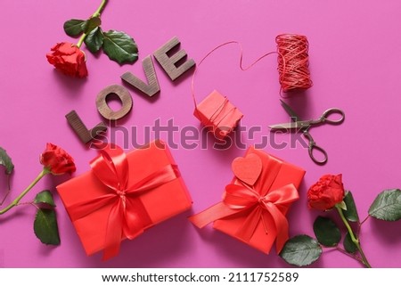 Composition with gifts for Valentine's Day, rose flowers and word LOVE on color background