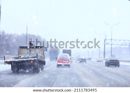 snowfall in city traffic jam in winter, background seasonal snow highway road