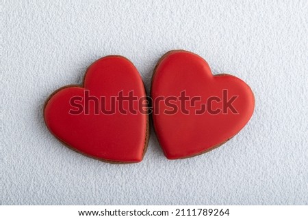 Homemade red Valentines Day cookies shape of hearts on white background.