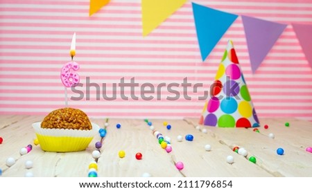 Happy birthday for 6 years old. Festive background with muffin. Copy the birthday card for a six year old on a pink background.