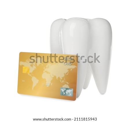 Ceramic model of tooth and credit card on white background. Expensive treatment