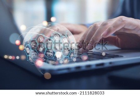 Internet of Things (IOT) technology, Woman using laptop computer with E-commerce technology icons on virtual global network, Global business, Social media marketing concept. Royalty-Free Stock Photo #2111828033