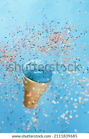 colorful ice cream in a waffle cup on a blue background
