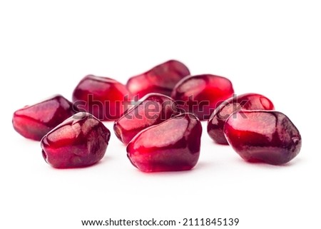 Garnet fruit seeds with water drops isolated on white background. Group of pomegranate seeds closeup. Fresh garnet grains macro shot Royalty-Free Stock Photo #2111845139