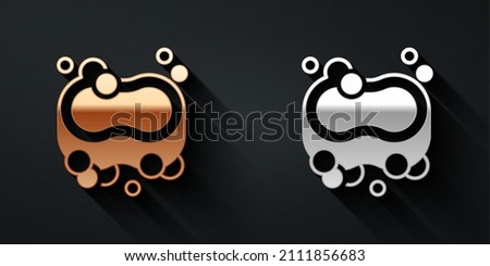 Gold and silver Bar of soap icon isolated on black background. Soap bar with bubbles. Long shadow style. Vector