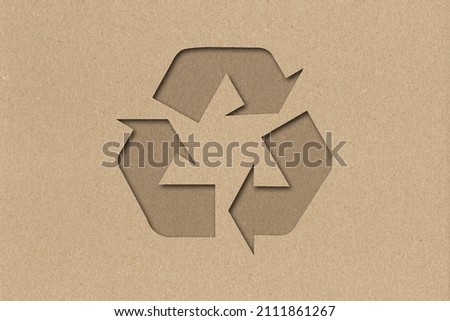 Symbol of waste recycling in the style of paper clippings. Ecological concept. The green planet. Earth Day. Mother Nature. Recycling. Biodegradable material. Secondary use of natural resources. Craft Royalty-Free Stock Photo #2111861267
