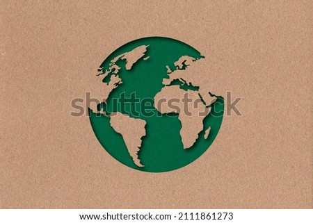 The silhouette of the planet in the style of paper clippings. Ecological concept. Green planet. Earth Day. Mother Nature. Recycling. Biodegradable material. Craft Royalty-Free Stock Photo #2111861273