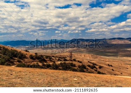 Mountain landscape. View of the mountain hills. Sunny, cloudy day. 