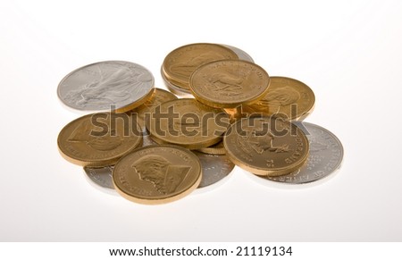 One Ounce gold Krugerrand coins from South Africa and One  ounce silver Walking Liberty coins from the United States  of America isolated on white.