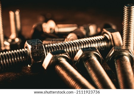 Close-up of various steel nuts and bolts. Selective focus. Macro photography.