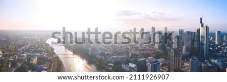 Wide panoramic aerial cityscape of Frankfurt am Main, Germany. Skyline panorama of the Bankenviertel financial centre skyscrapers at sunset. Royalty-Free Stock Photo #2111926907