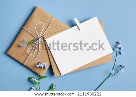 Greeting card mockup with gift box on blue