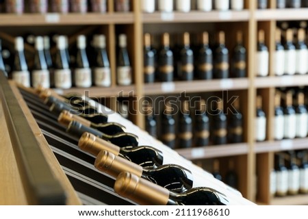 Wine bottles with blank labels on the counter of a liquor store. Wine background.