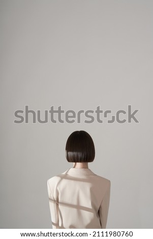 Beautiful brunette woman with natural makeup wear fashion pantsuit. Strict graphic bob haircut.  Business meeting Royalty-Free Stock Photo #2111980760
