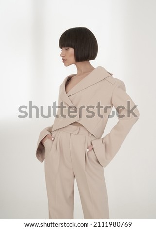 Beautiful brunette woman with natural makeup wear fashion pantsuit. 
Strict graphic bob haircut.  Business meeting
 Royalty-Free Stock Photo #2111980769