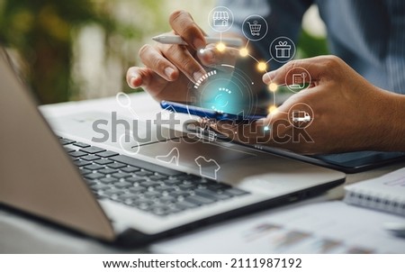 Businessman with mobile smartphone in hand paying online and shopping on virtual interface global network, online banking and digital marketing.