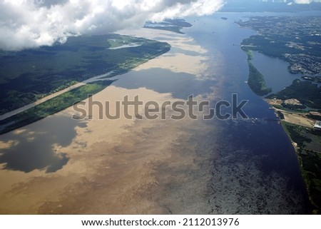 The Meeting of Waters is the confluence between the Rio Negro, a river with dark (almost black coloured) water, and the sandy-coloured Amazon River or Rio Solimões. 