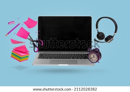 Creative minimal composition made with a laptop, headphones, school supplies and alarm clock flying in the air. Back to school. Online teaching. Minimal, conceptual art. Suitable for advertising