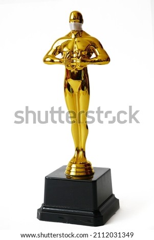 Hollywood Golden Oscar Academy award statue im mask isolated on white background with copy space. Success and victory concept.