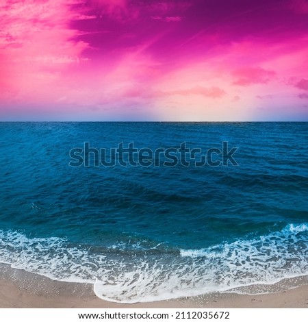 Vibrant saturated seascape with turquoise-colored seawater, and pink foggy clouds at sunset