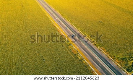 Aerial view of A2 beautiful highway motorway road in Romania through sunflower fields, between Bucharest and Constanta cities. Amazing beautiful road.