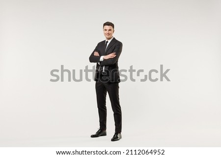 Full length young successful employee business corporate lawyer man in classic formal black grey suit shirt tie work in office hold hands crossed folded isolated on white background studio portrait. Royalty-Free Stock Photo #2112064952