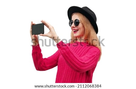 Portrait of happy laughing young woman taking selfie by smartphone isolated on white background