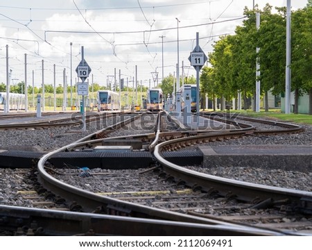 Rail junction in a deppot of trams. Crossing railroad tracks with switches and traffic lights.