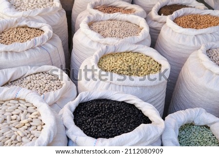 Aerial view of various types of legumes in open sacks at a local vegan market