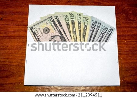 Dollars on the table with an envelope. Money in an envelope. U.S. dollars.
